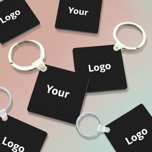 Black keychains featuring the words “Your” and “Logo.”